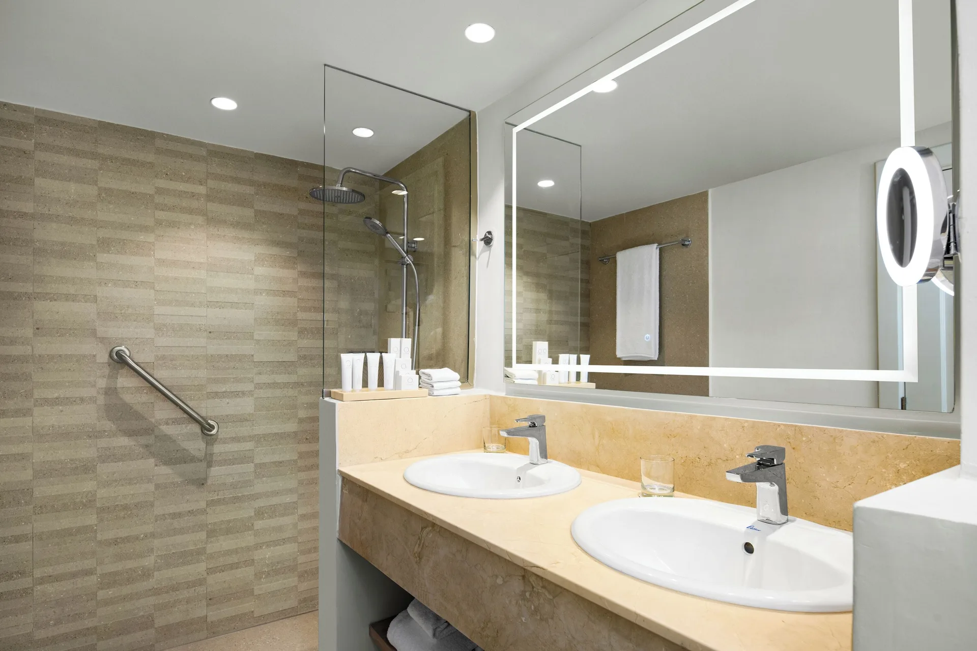 Club Level Junior Suite bathroom with double sinks and glass shower at Wyndham Alltra Punta Cana with modern resort design.