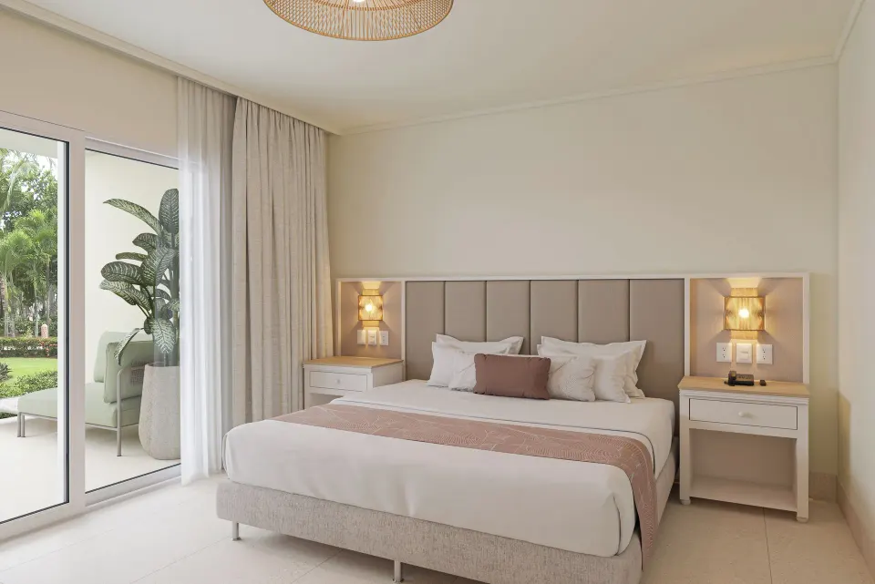 King bedroom with balcony in a two-bedroom suite at Wyndham Alltra Punta Cana.