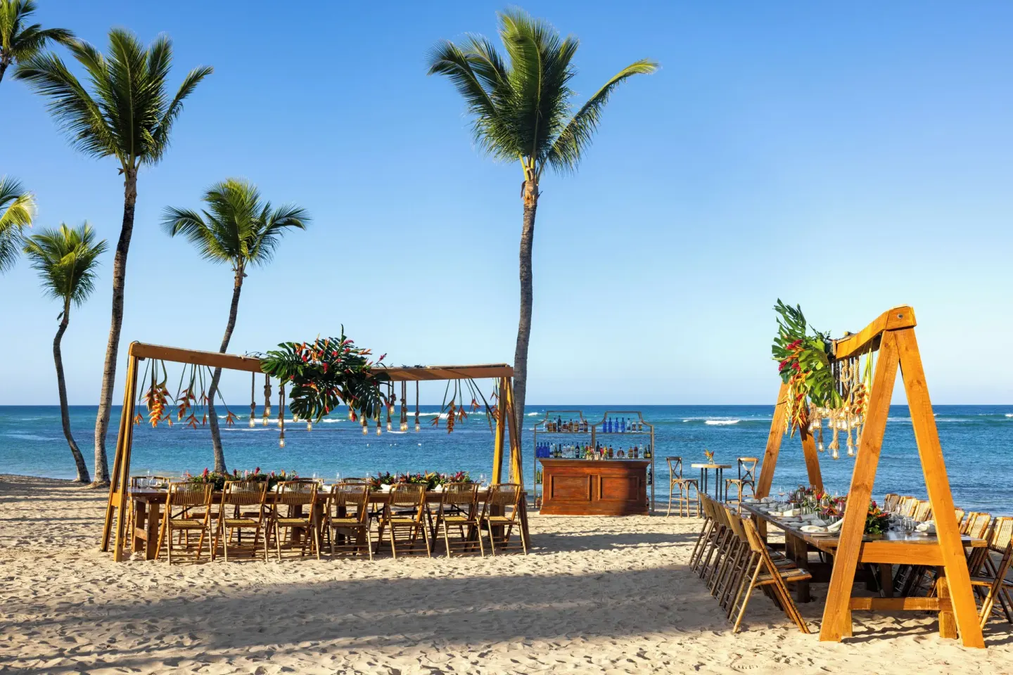 Beach event setup with long tables and ocean view at Wyndham Alltra Punta Cana.