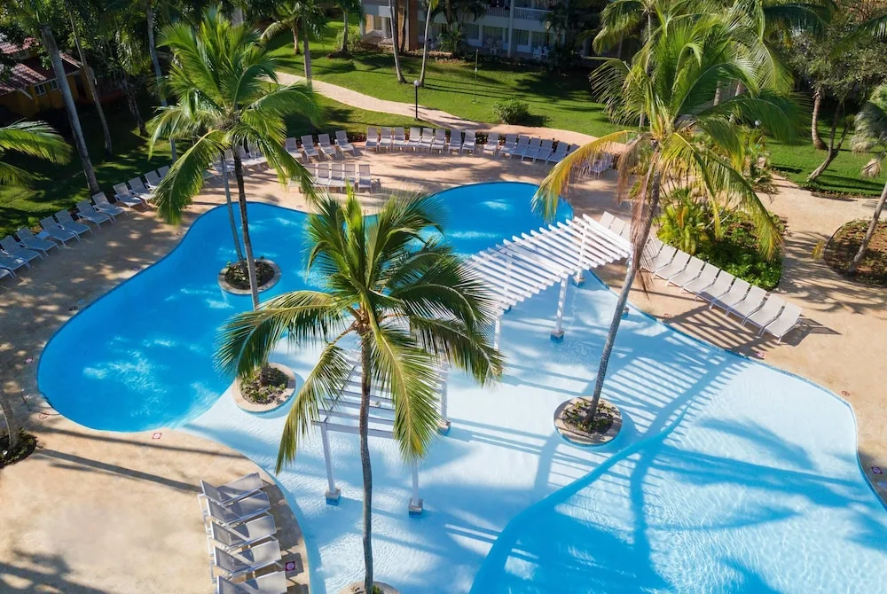 Aerial view of the palm-lined pool at Wyndham Alltra Samana Resort.