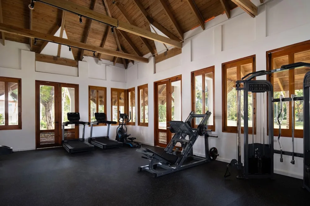 Fitness center with cardio and strength machines at Wyndham Alltra Samana Resort.