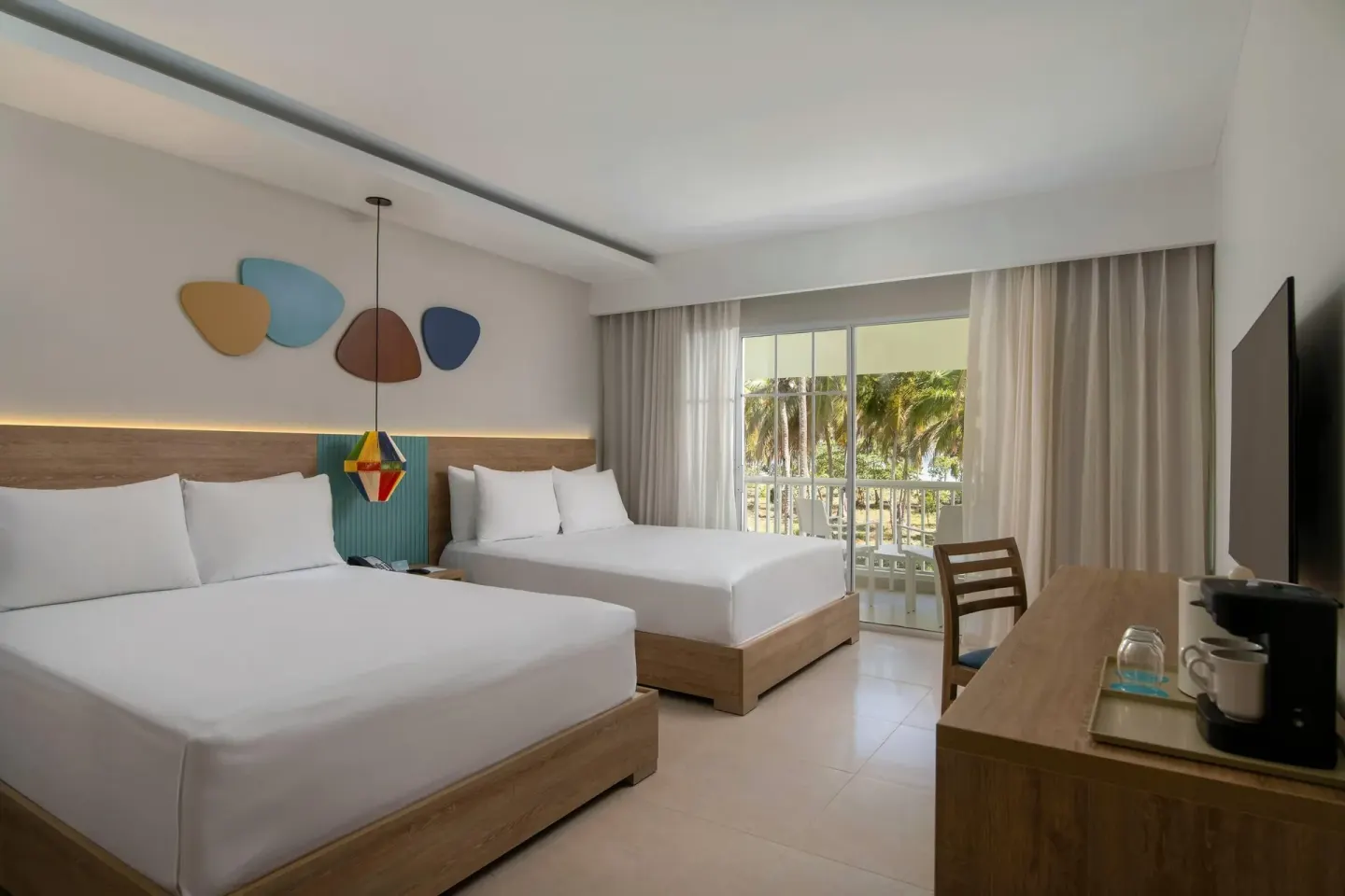 Two-bed guest room with balcony doors and TV console at Wyndham Alltra Samana Resort.