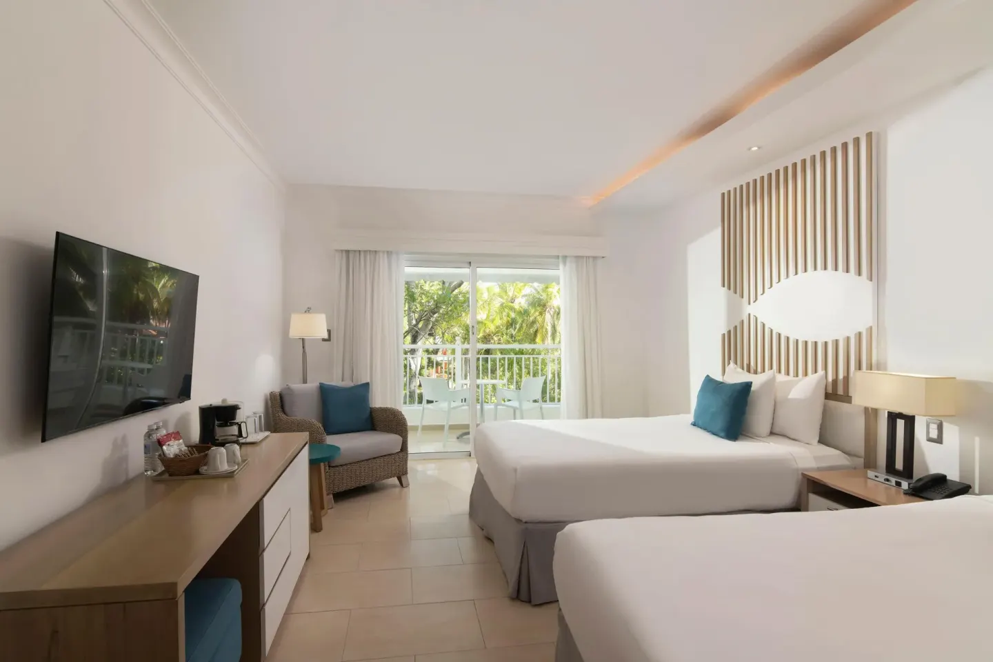 Two-bed guest room with balcony seating at Wyndham Alltra Samana Resort.