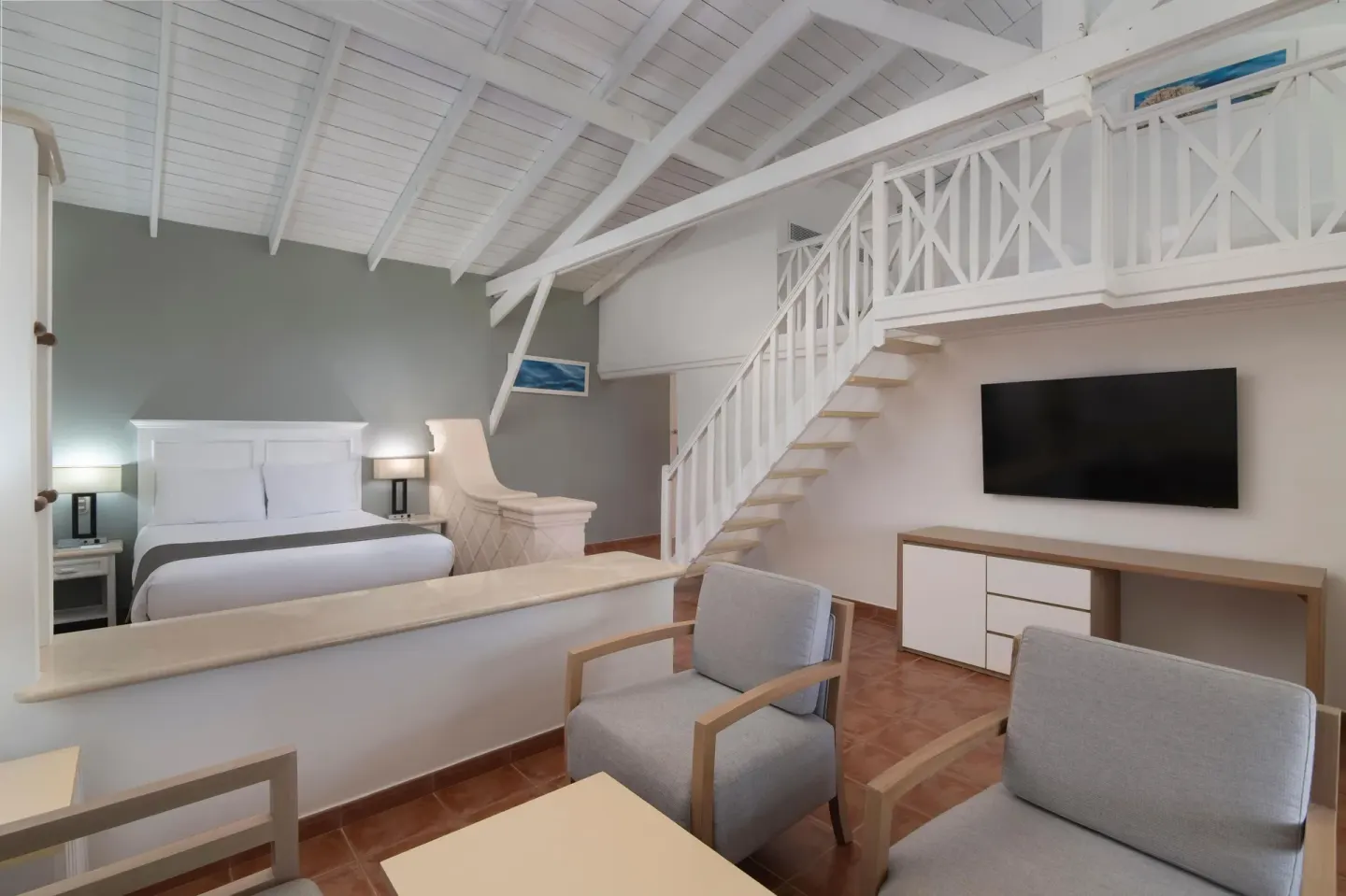 Loft-style king guest room with sitting area at Wyndham Alltra Samana Resort.