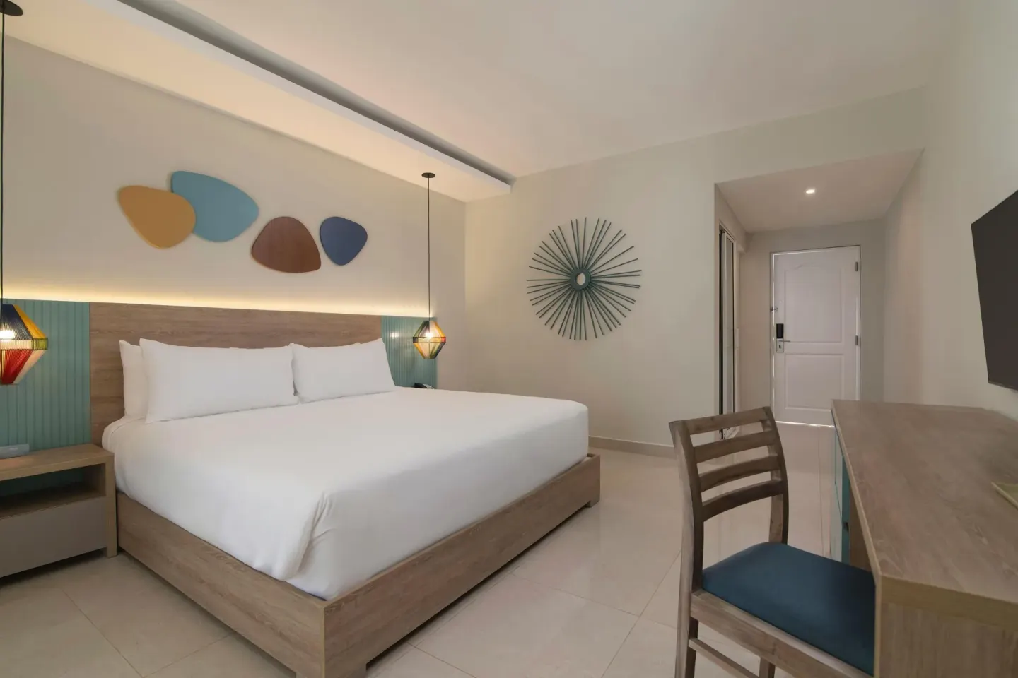 Modern king guest room with desk and wall art at Wyndham Alltra Samana Resort.