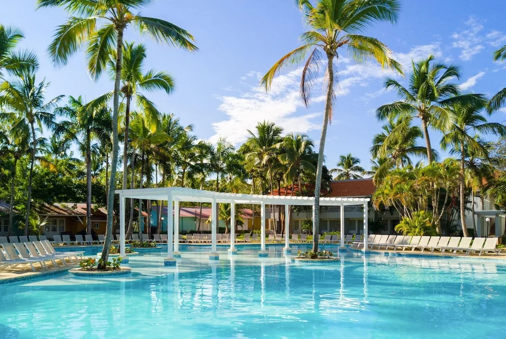 Palm trees reflected in the resort pool at Wyndham Alltra Samana Resort.