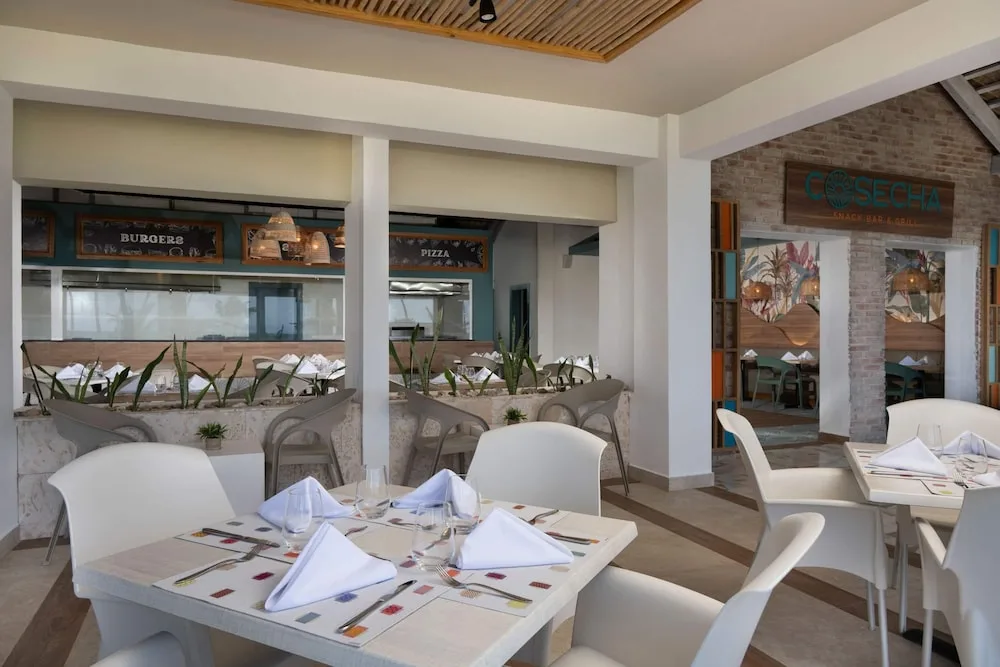 Tables are set near Cosecha and casual food counters at Wyndham Alltra Samana Resort.