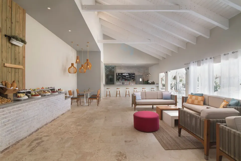 Club lounge buffet and seating at Wyndham Alltra Samana Resort.