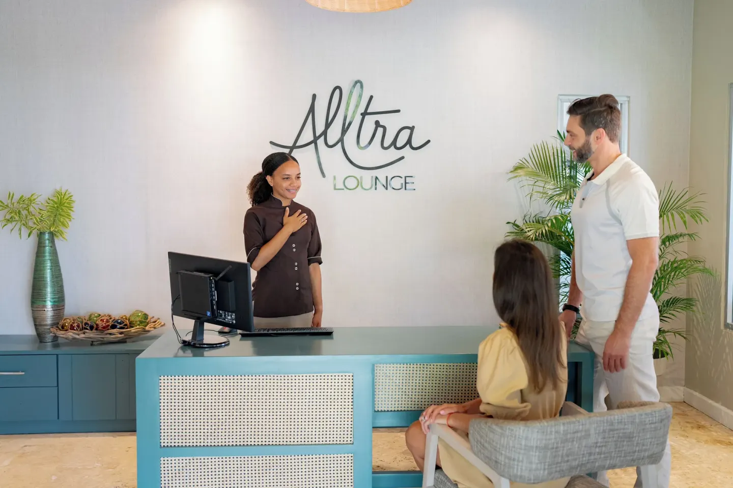 Guests at the Alltra Lounge reception desk at Wyndham Alltra Samana Resort.