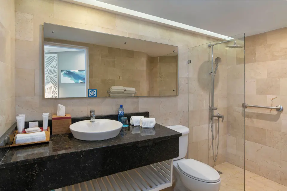 Club Room Ocean View bathroom with glass shower at Wyndham Alltra Samana Resort.
