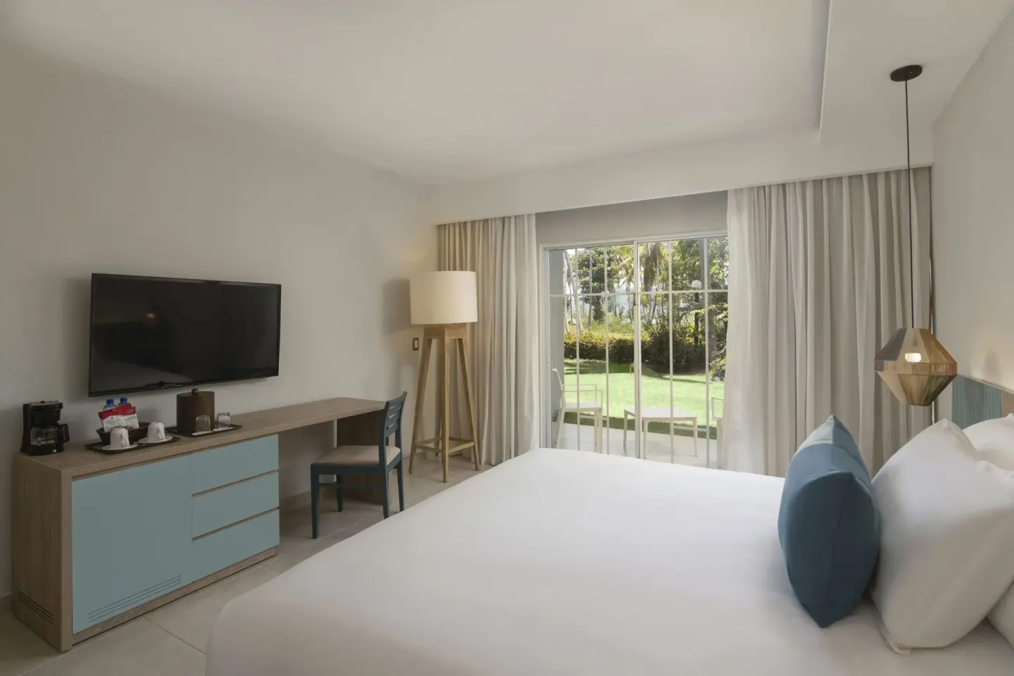 Standard Room Garden View king bed with TV console at Wyndham Alltra Samana Resort.