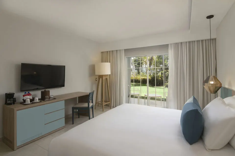 Standard Room Garden View king bed with TV console at Wyndham Alltra Samana Resort.