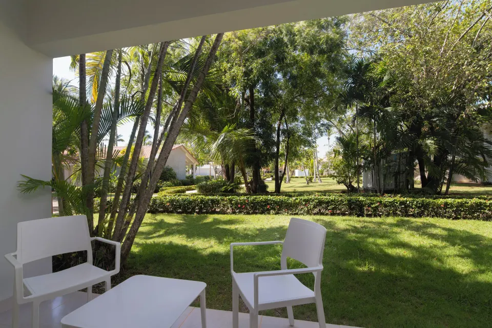Standard Room Garden View patio with chairs at Wyndham Alltra Samana Resort.
