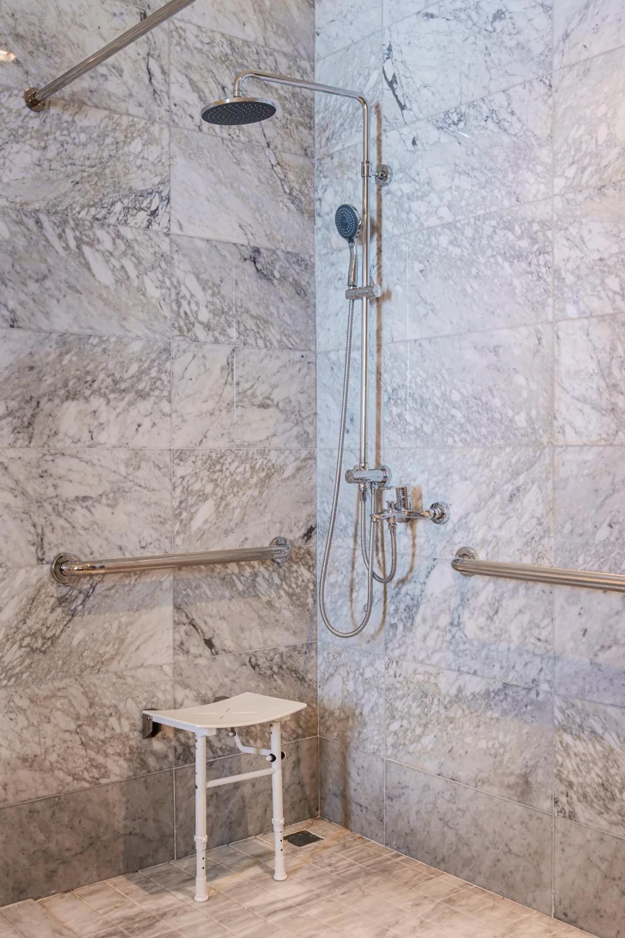 Accessible shower with seat and grab bars at Wyndham Grand Barbados Sam Lords Castle.