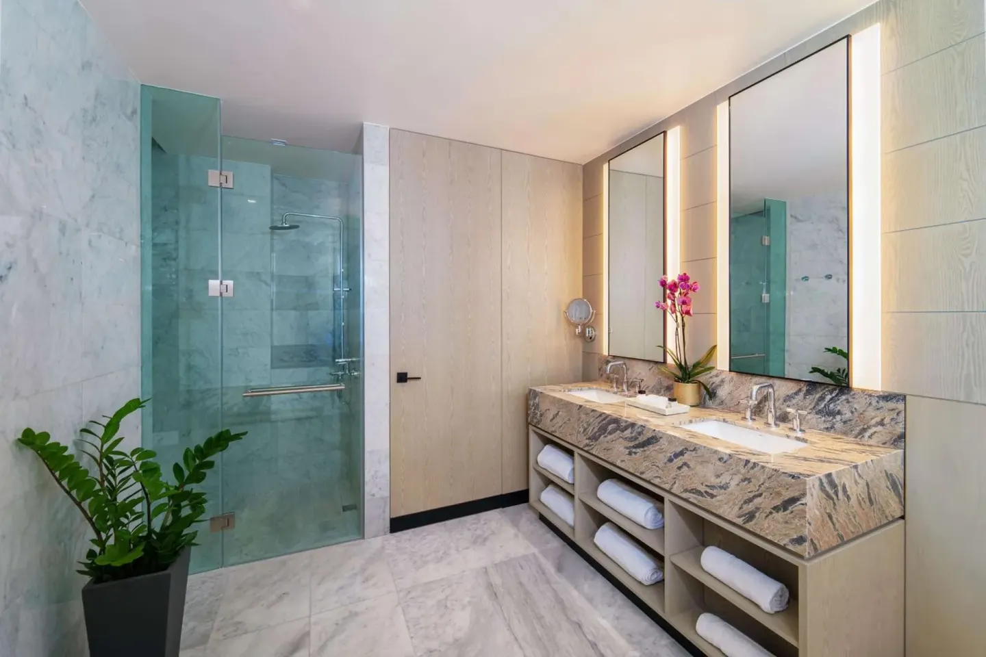 Marble bathroom with double vanity and glass shower at Wyndham Grand Barbados Sam Lords Castle.