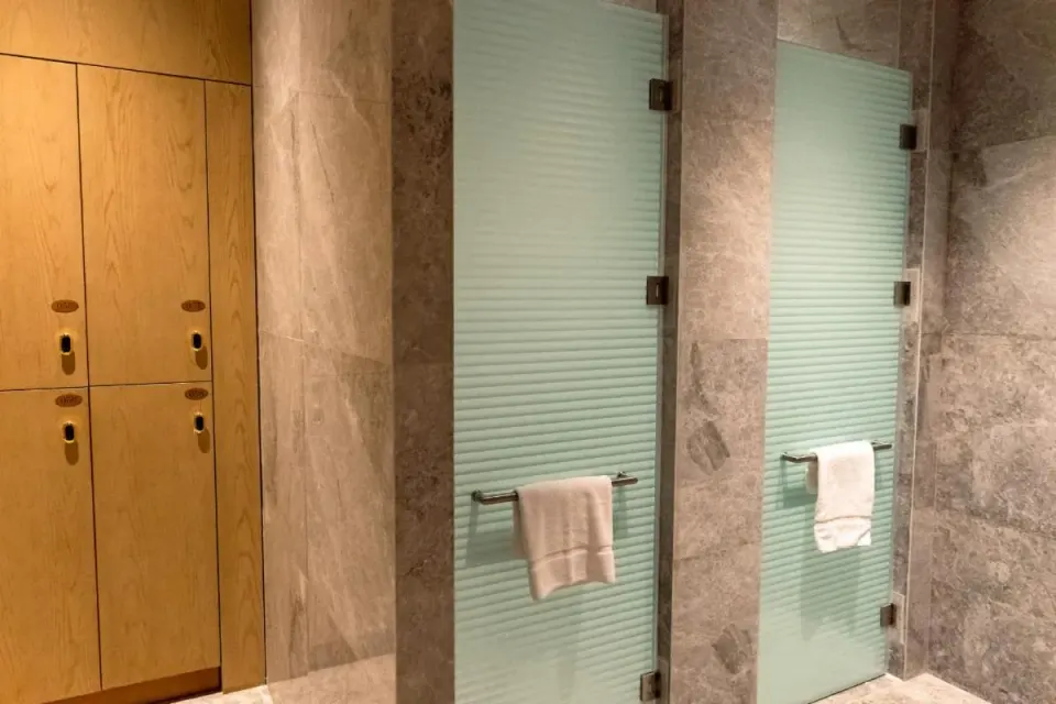 Spa-style shower stalls and wood lockers at Wyndham Grand Barbados Sam Lords Castle.