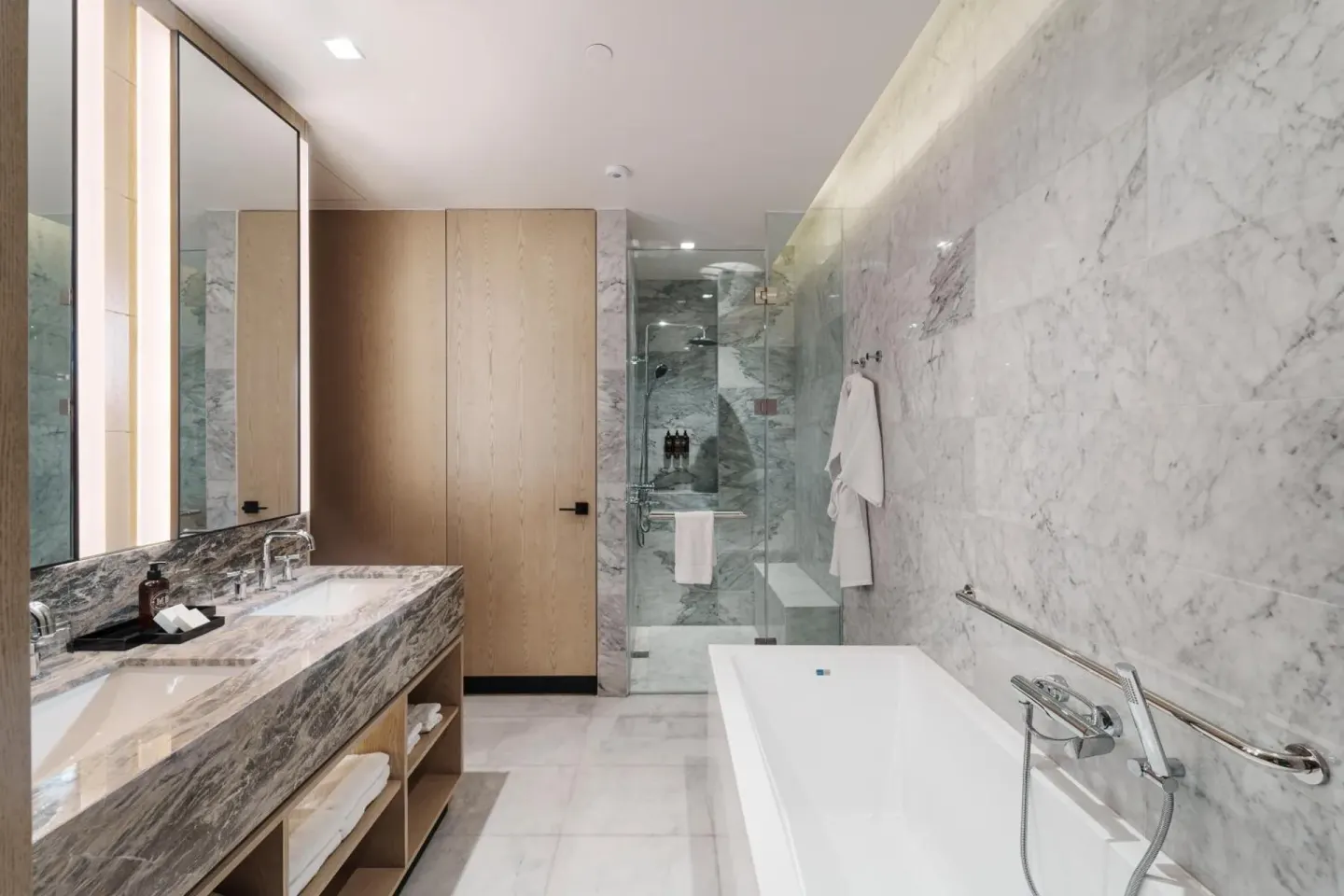 Marble bathroom with double vanity, soaking tub, and glass shower at Wyndham Grand Barbados Sam Lords Castle.