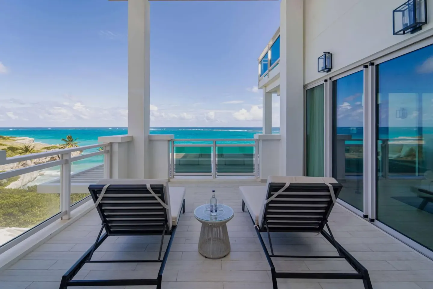 Ocean-facing terrace with two loungers at Wyndham Grand Barbados Sam Lords Castle.