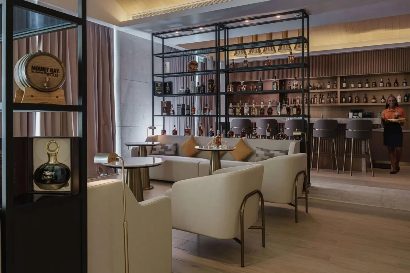 Rum bar lounge with shelves of bottles at Wyndham Grand Barbados Sam Lords Castle.