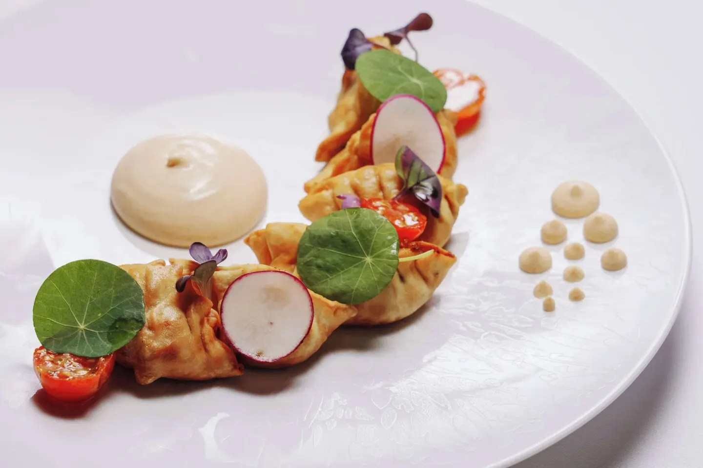 Plated dumplings with garnishes at Wyndham Grand Barbados Sam Lords Castle.