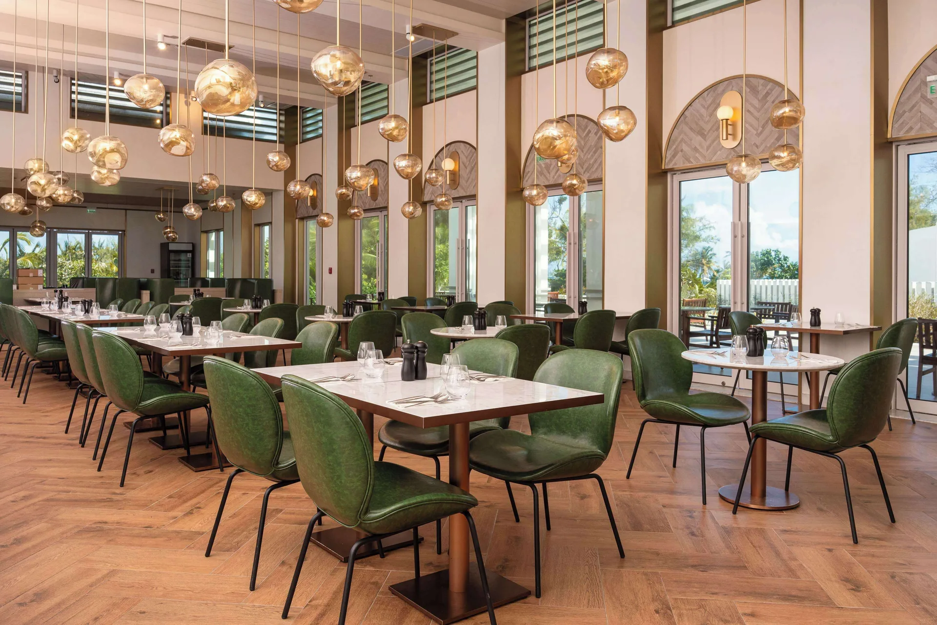 Restaurant dining room with green chairs at Wyndham Grand Barbados Sam Lords Castle.