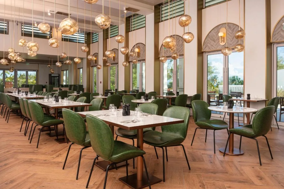 Restaurant dining room with green chairs at Wyndham Grand Barbados Sam Lords Castle.
