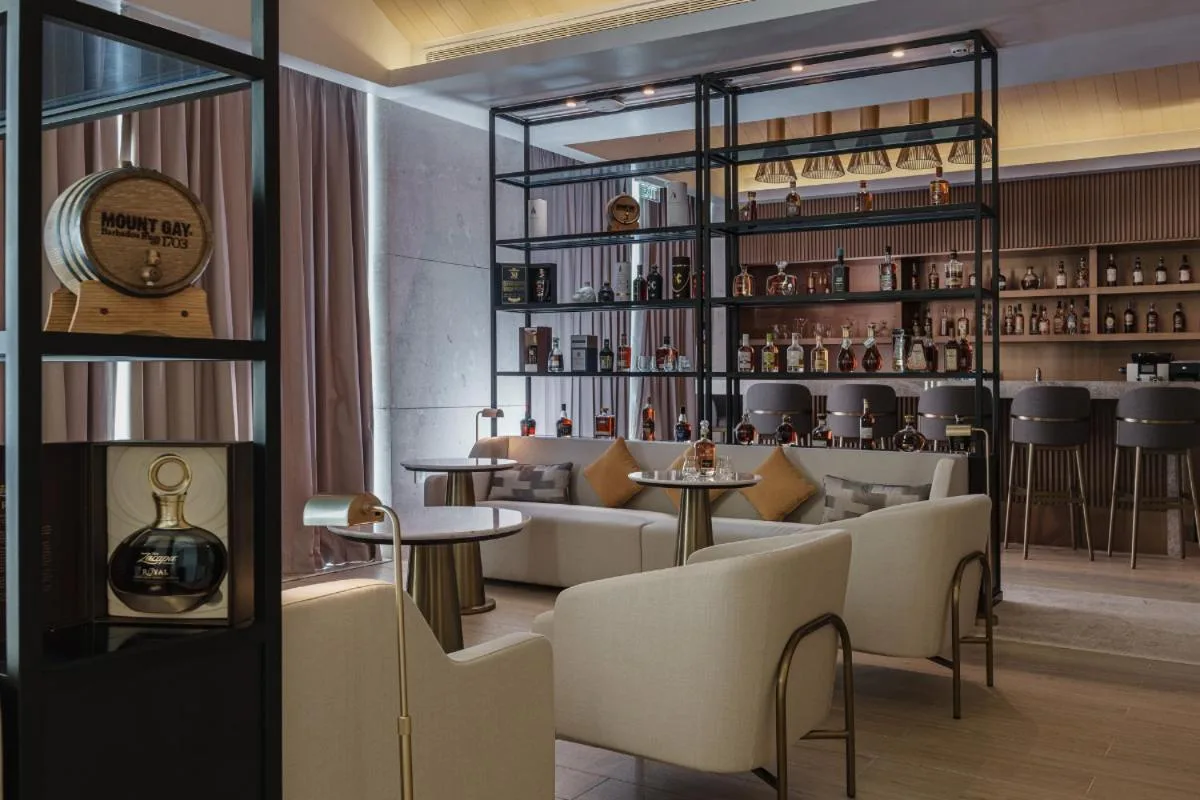 Rum bar lounge seating and bottle displays at Wyndham Grand Barbados Sam Lords Castle.