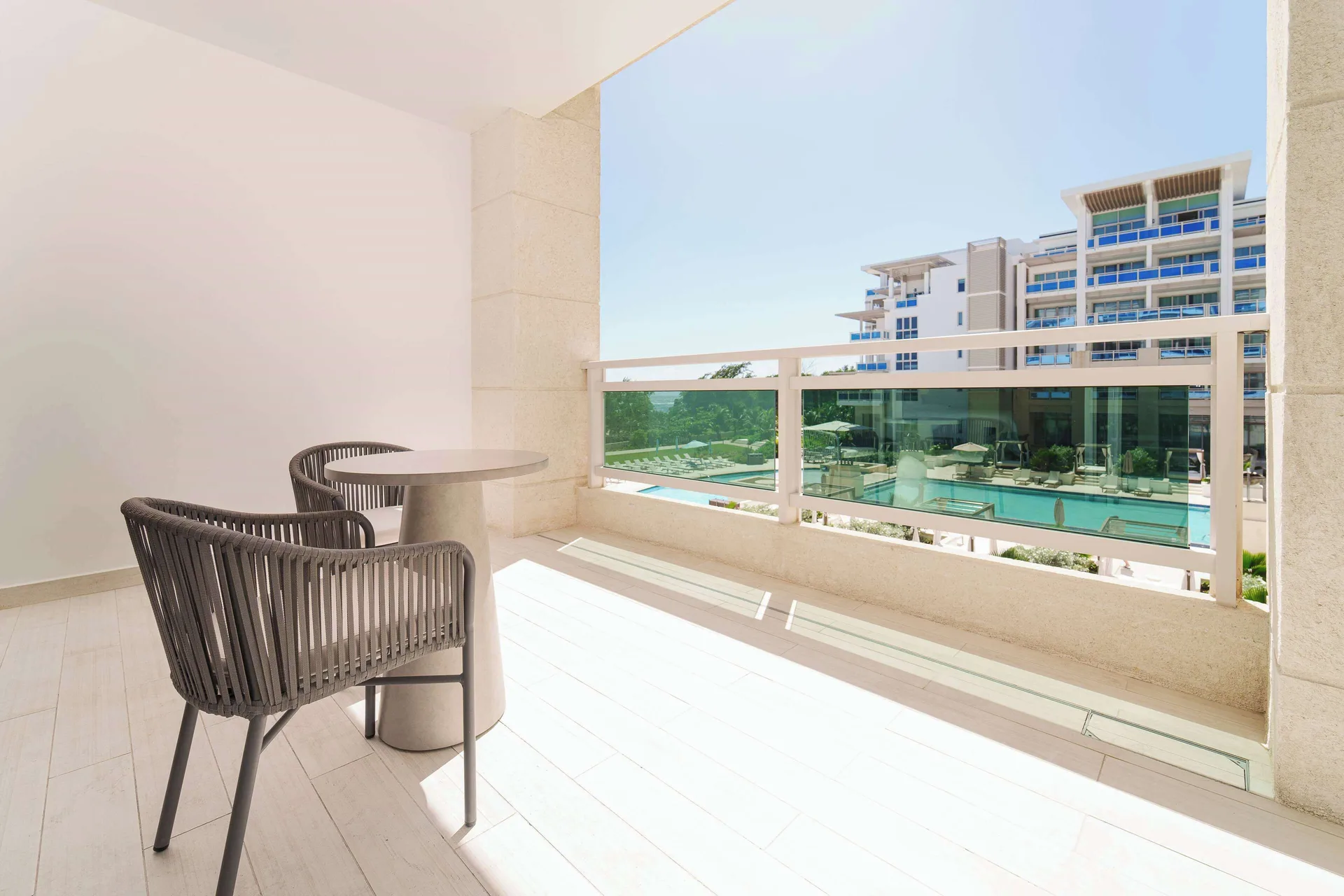 Furnished balcony with resort pool view at Wyndham Grand Barbados Sam Lords Castle.