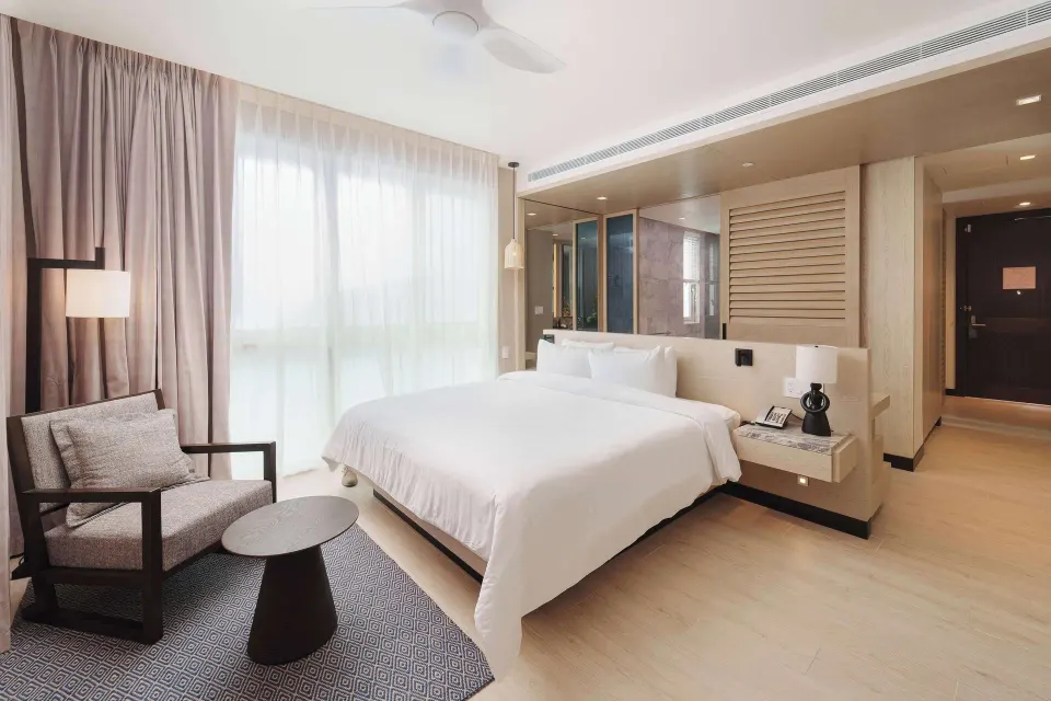 King bed and sitting area in a Deluxe Room Resort View at Wyndham Grand Barbados Sam Lords Castle.