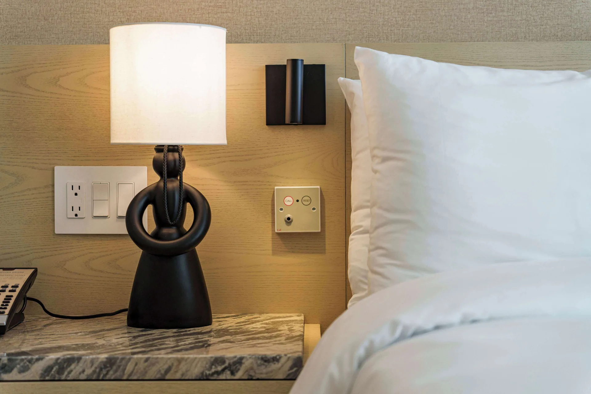 Accessible Resort View room bedside lamp and pillows at Wyndham Grand Barbados Sam Lords Castle.
