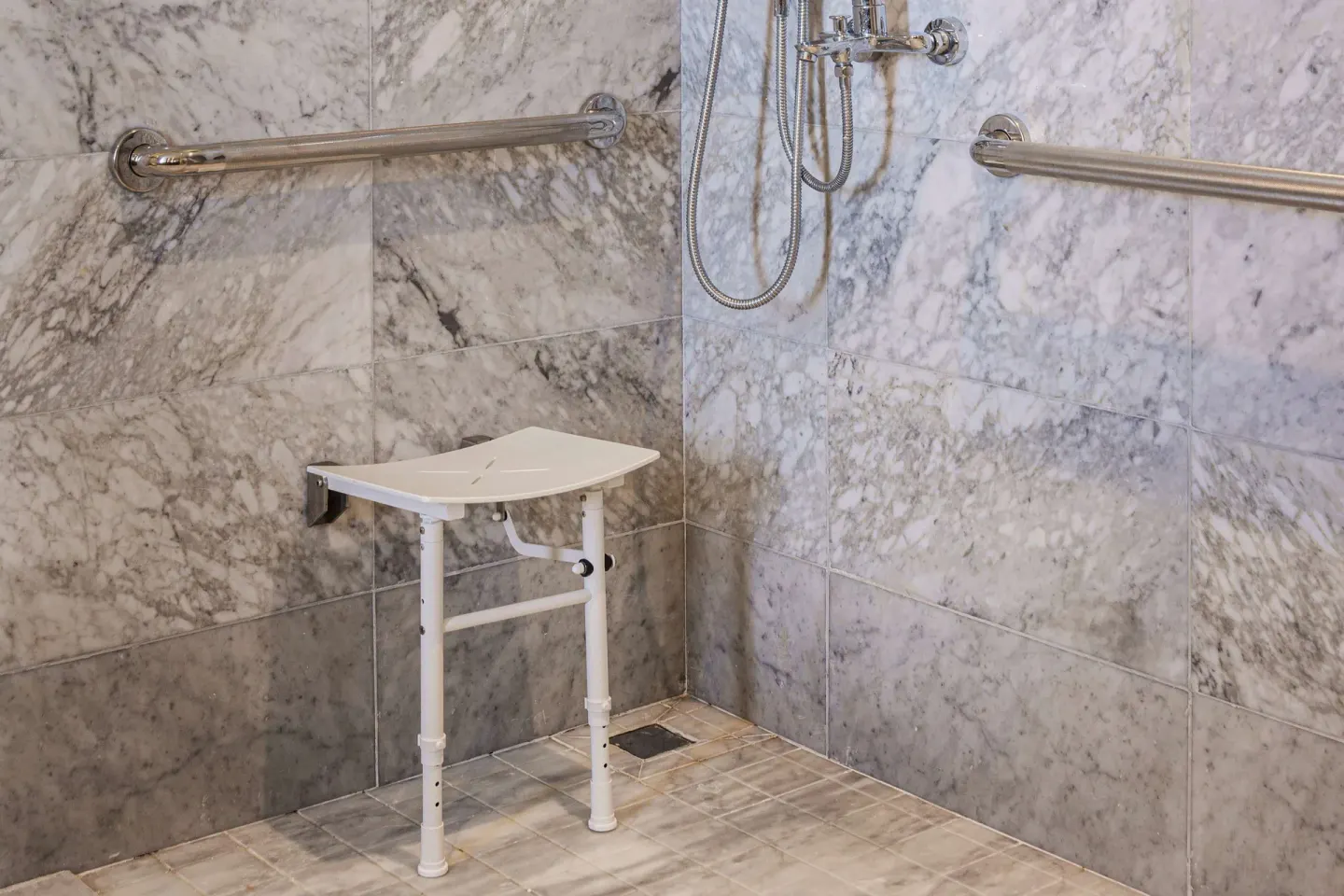 Accessible roll-in shower seat and grab bars at Wyndham Grand Barbados Sam Lords Castle.