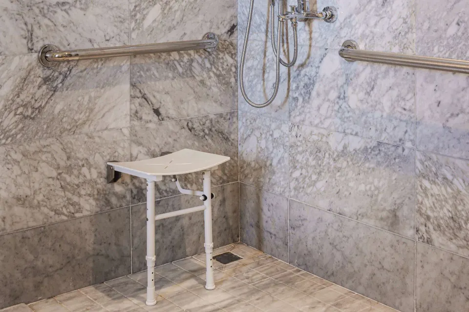 Accessible roll-in shower seat and grab bars at Wyndham Grand Barbados Sam Lords Castle.