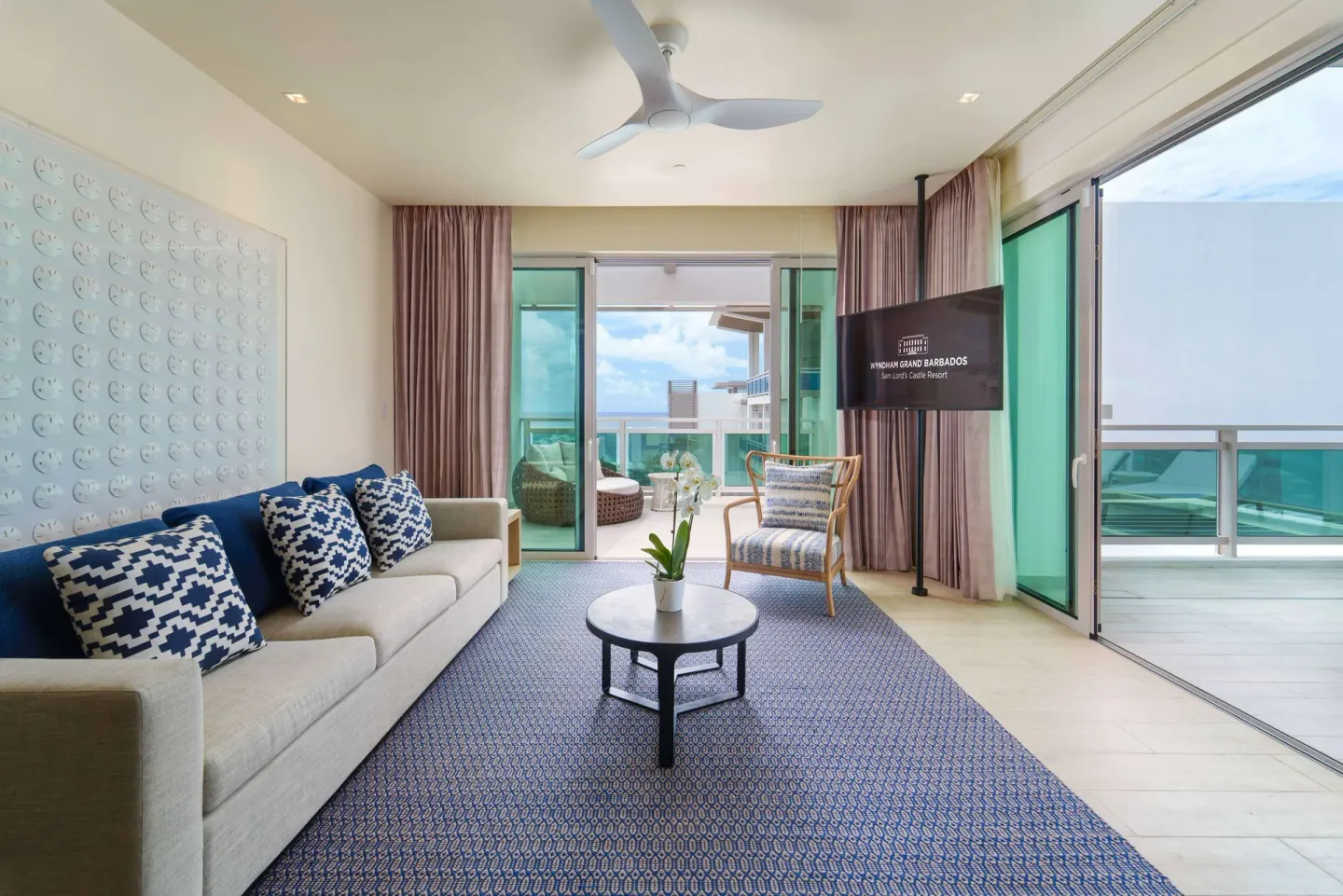 Suite living area with balcony doors at Wyndham Grand Barbados Sam Lords Castle.
