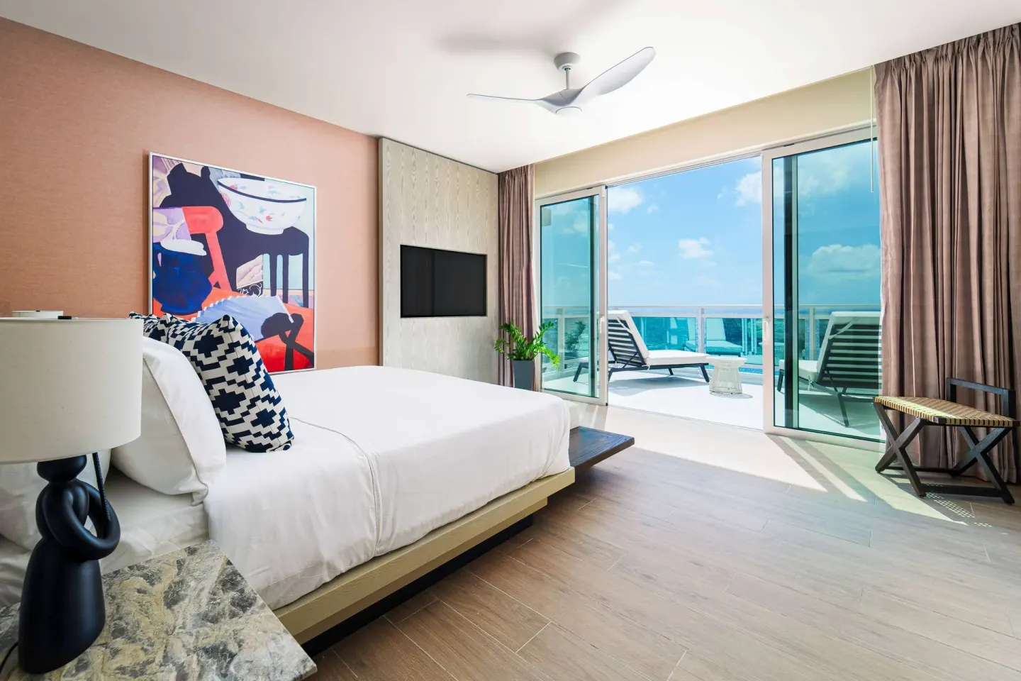Suite king bed and furnished balcony at Wyndham Grand Barbados Sam Lords Castle.