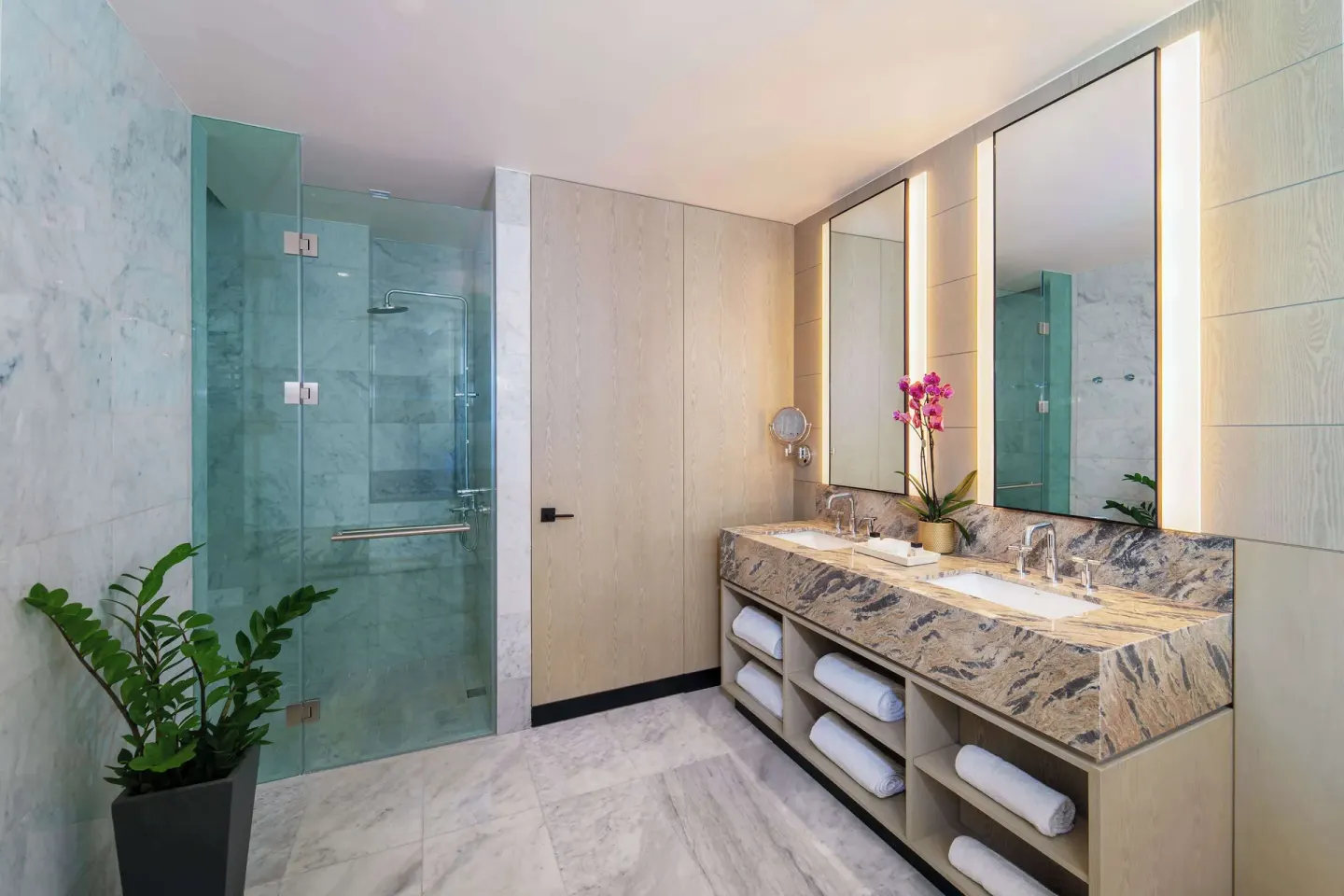 Zephyr Suite bathroom with double vanity and glass shower at Wyndham Grand Barbados Sam Lords Castle.