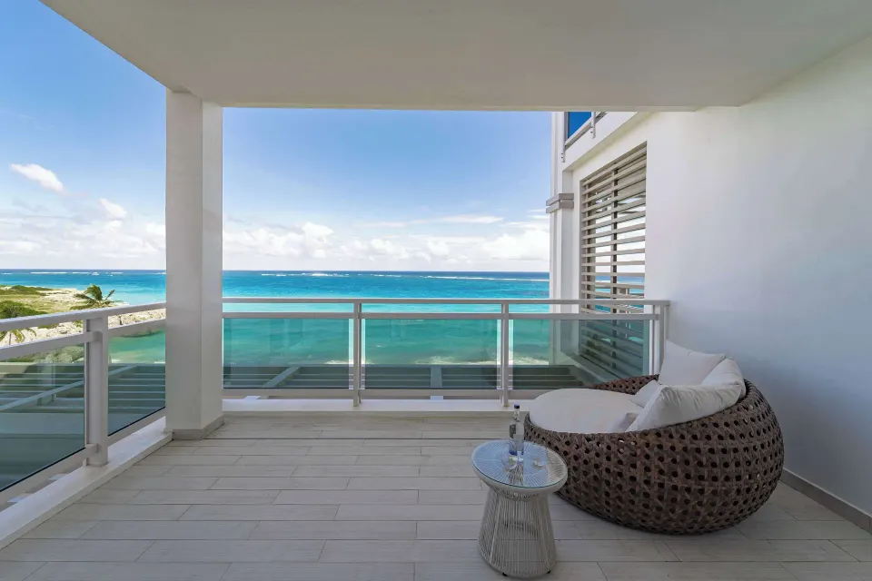 Zephyr Suite covered balcony seating with sea view at Wyndham Grand Barbados Sam Lords Castle.