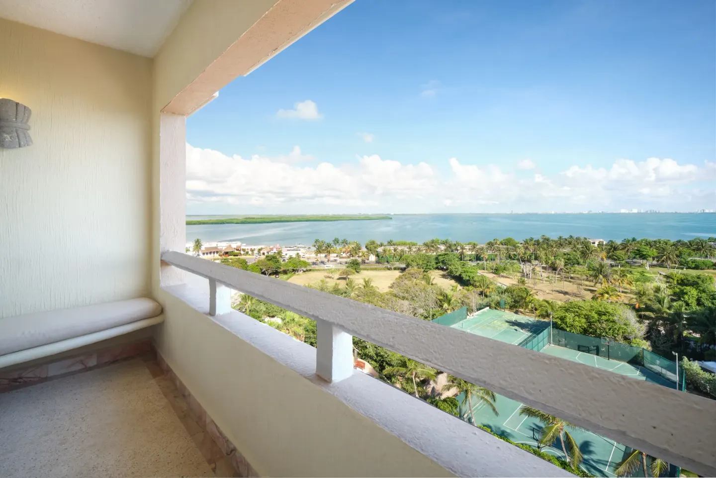 Balcony with lagoon and tennis court view at Wyndham Grand Cancun Resort & Villas.