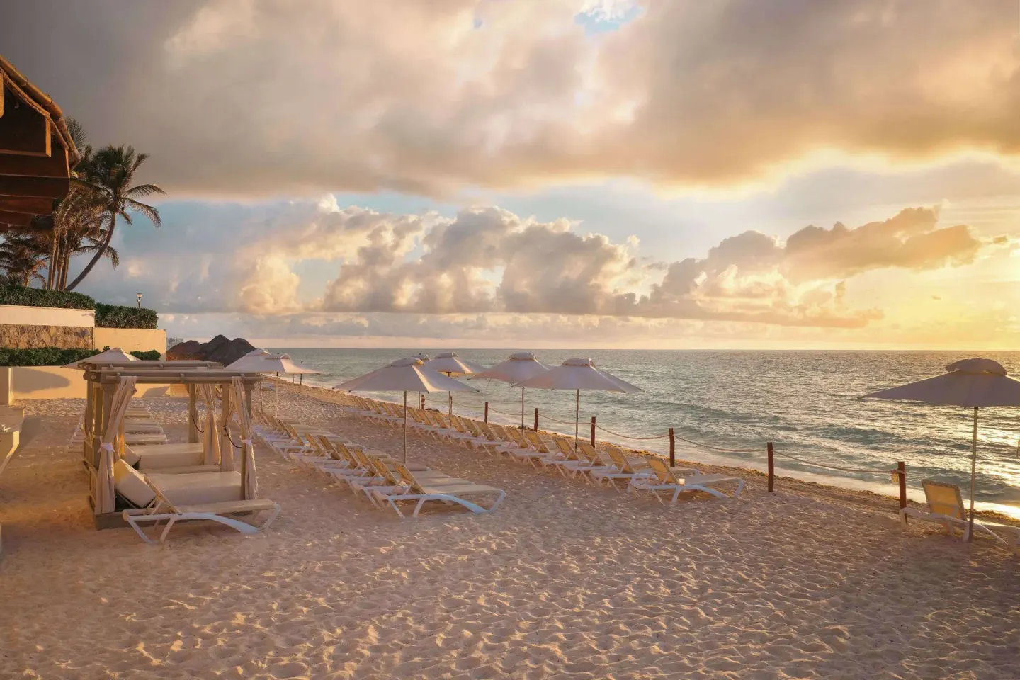 Sunrise beach loungers and umbrellas at Wyndham Grand Cancun Resort & Villas.