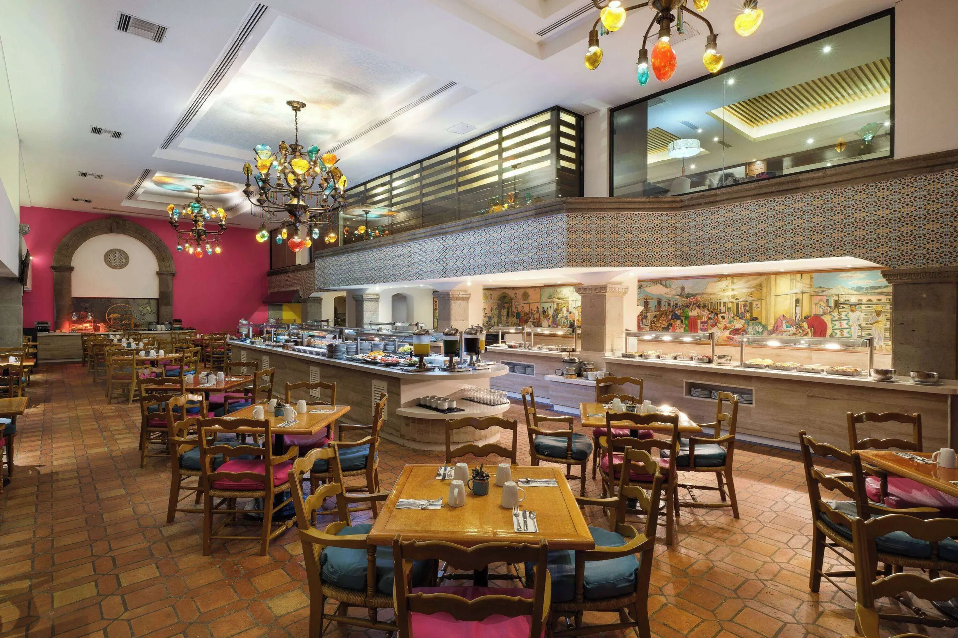 La Paloma buffet dining room at Wyndham Grand Cancun Resort & Villas with colorful chandeliers and tables.