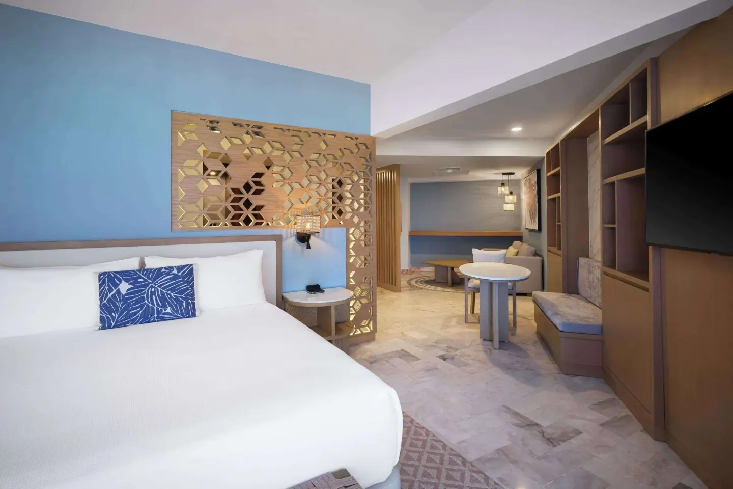 Executive Suite king bed with seating and TV at Wyndham Grand Cancun Resort & Villas.
