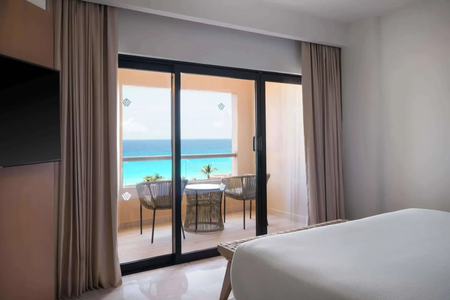 Executive Suite bedroom and balcony ocean view at Wyndham Grand Cancun Resort & Villas.