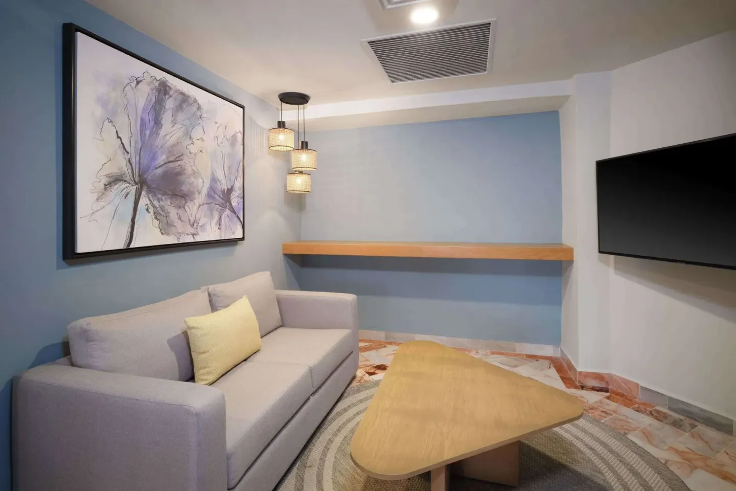 Executive Suite lounge area with sofa and TV at Wyndham Grand Cancun Resort & Villas.