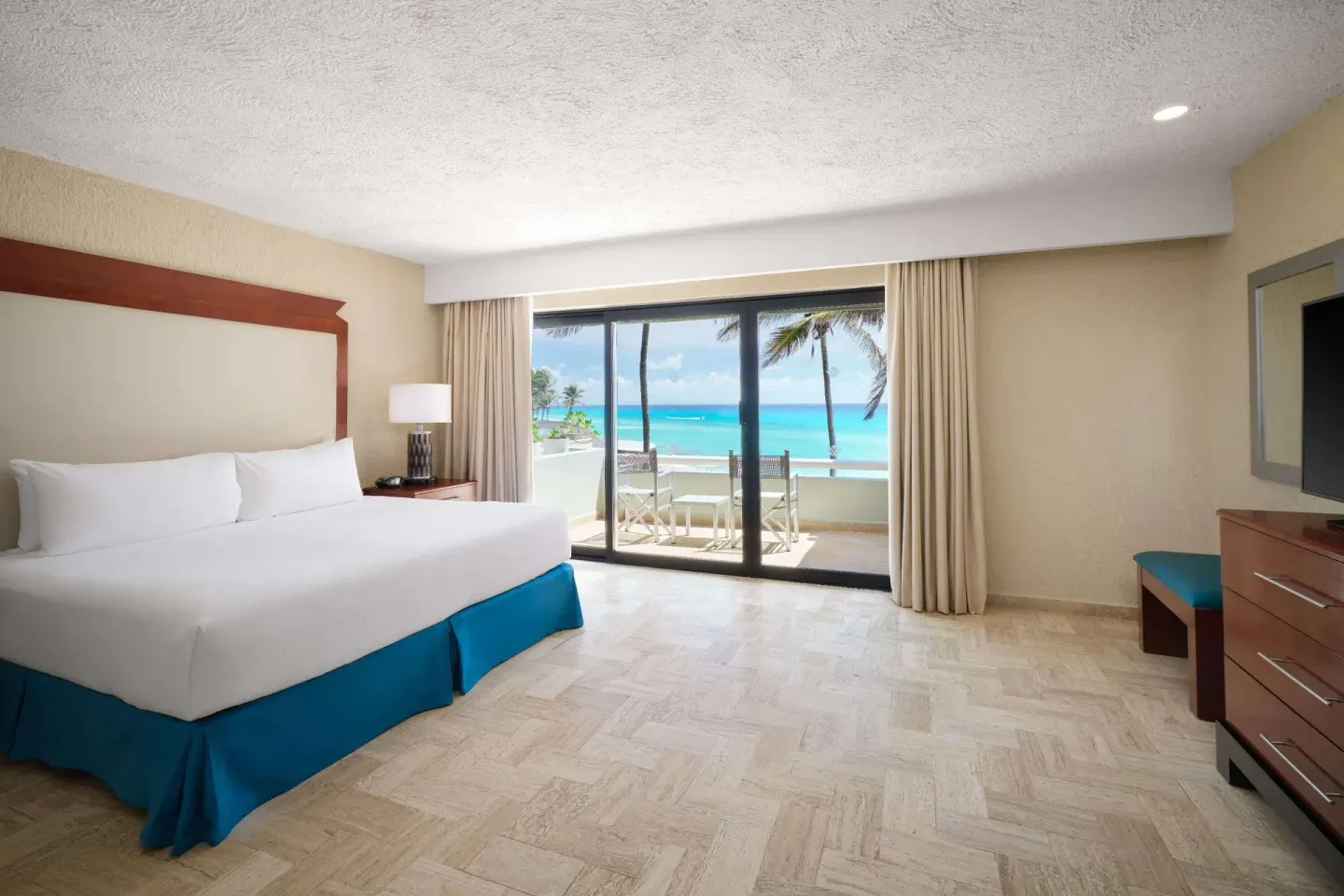 Non-smoking king bedroom with balcony ocean view at Wyndham Grand Cancun Resort & Villas.
