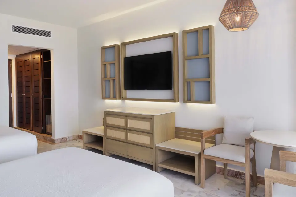 Superior Lagoon View room seating and TV at Wyndham Grand Cancun Resort & Villas.