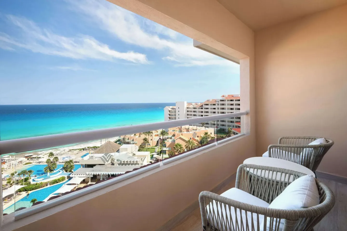 Superior Ocean View balcony with chairs at Wyndham Grand Cancun Resort & Villas.
