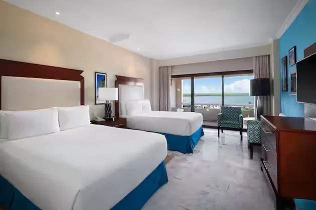Superior Vista a La Laguna room with two beds and balcony view at Wyndham Grand Cancun Resort & Villas.