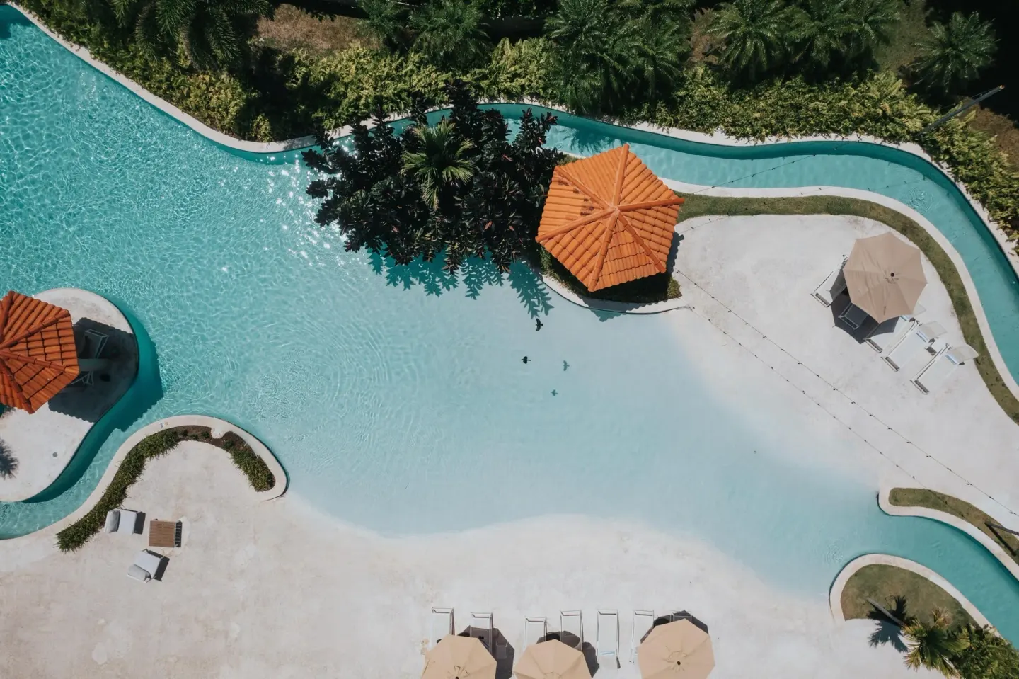 Aerial view of the curving pool and sundeck at Wyndham Palmas Beach and Golf Boutique Resort.
