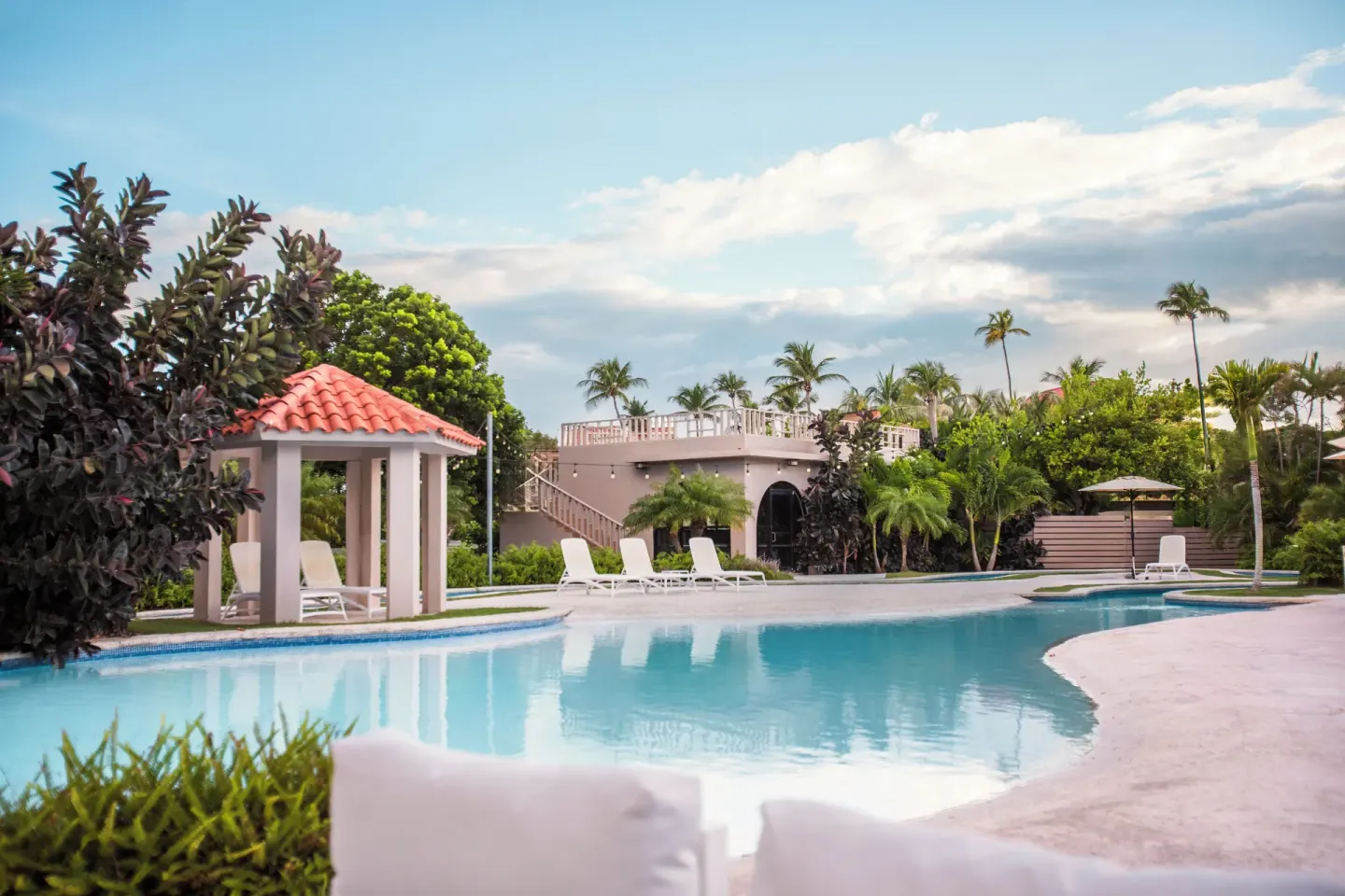 Curved pool with cabana and loungers at Wyndham Palmas Beach and Golf Boutique Resort.