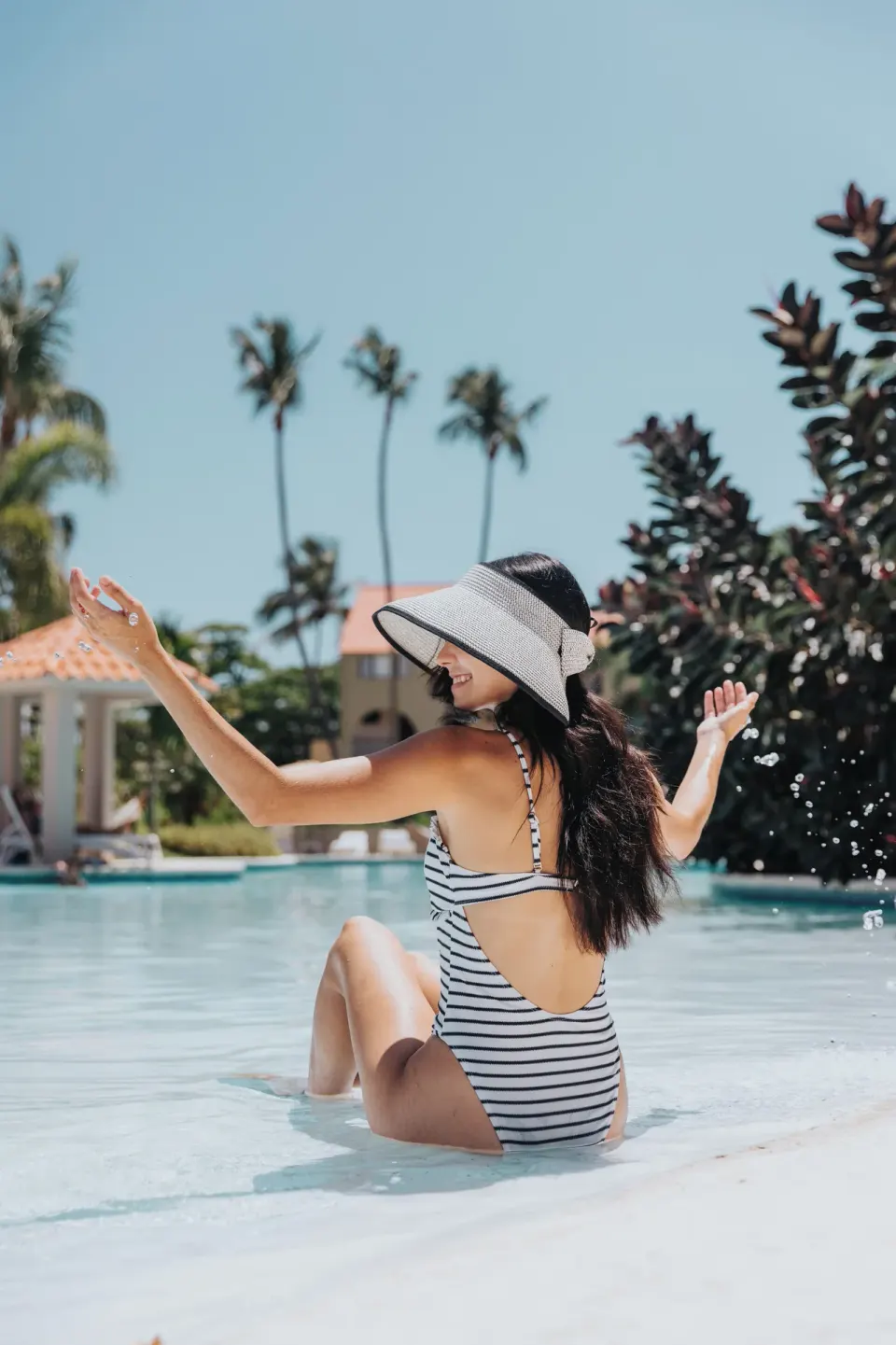 Guest splashing in the shallow pool at Wyndham Palmas Beach and Golf Boutique Resort.