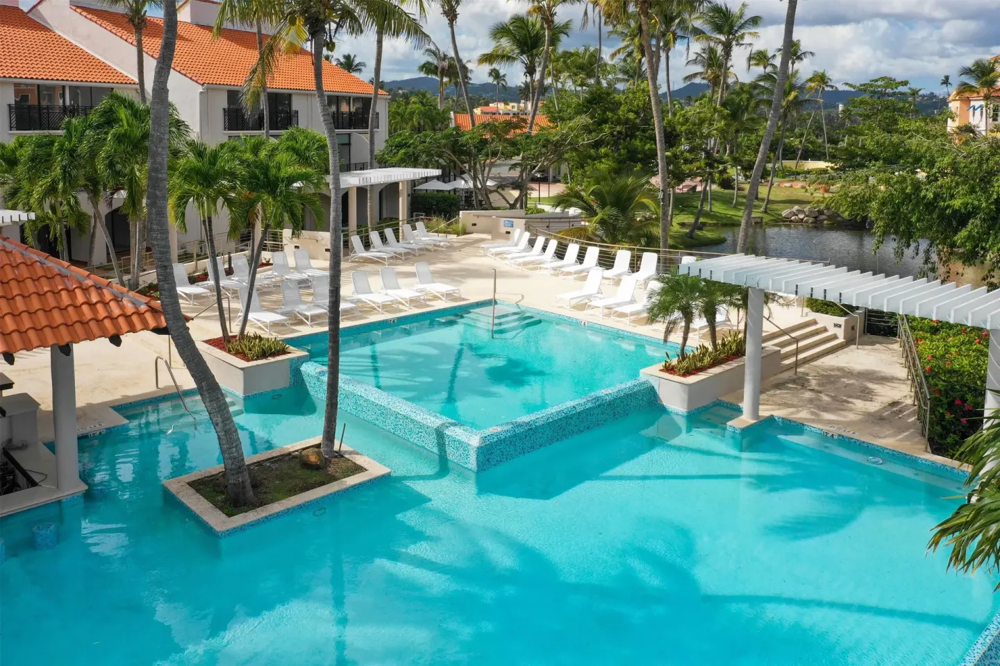 Main pool with loungers and palms at Wyndham Palmas Beach and Golf Boutique Resort.